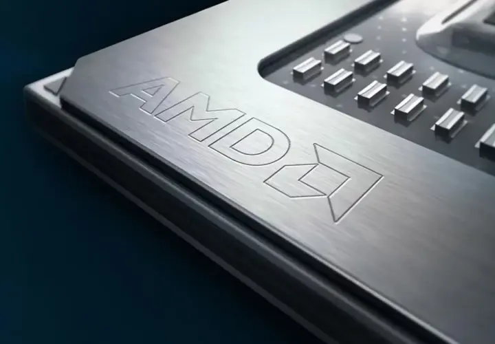 Metalowa powierzchnia procesora AMD z wygrawerowanym logo. To potężny Ryzen 9 6900HX, serce nowoczesnych laptopów gamingowych.