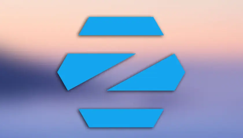Niebieskie, geometryczne kształty na tle gradientu przypominającego zachód słońca. Logo Zorin OS, popularnego systemu linux.