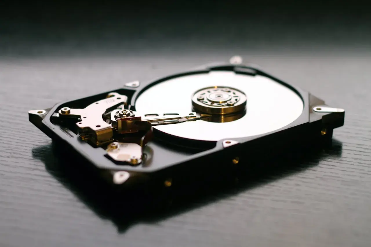 Wnętrze dysku HDD, z widocznymi talerzami i głowicami, kontrastuje z nowoczesnymi dyskami SSD.