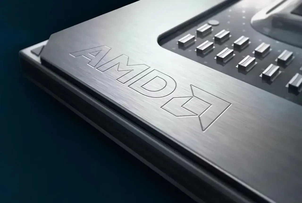 Metalowa powierzchnia procesora AMD z wygrawerowanym logo. To potężny Ryzen 9 6900HX, serce nowoczesnych laptopów gamingowych.