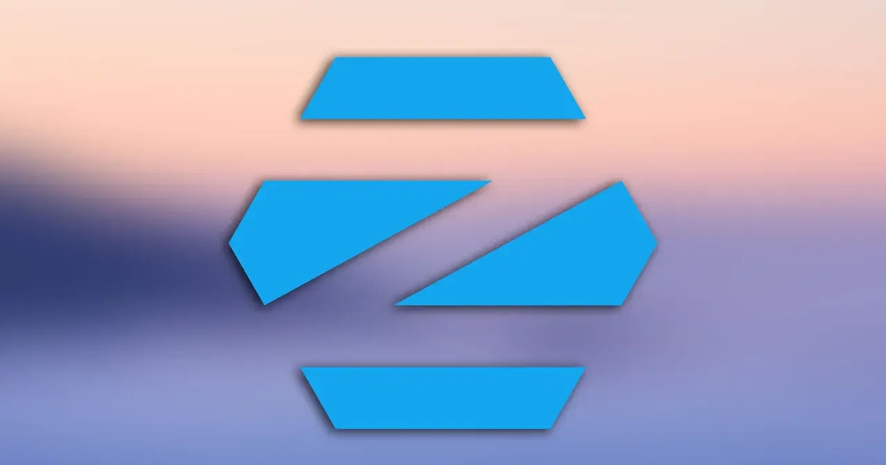 Niebieskie, geometryczne kształty na tle gradientu przypominającego zachód słońca. Logo Zorin OS, popularnego systemu linux.