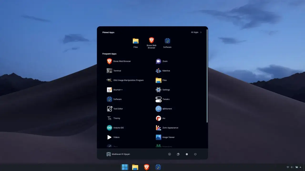 Menu aplikacji w Zorin OS, systemie Linux, z ikonami takich jak Brave Browser, Terminal, GIMP i Zorin Appearance.